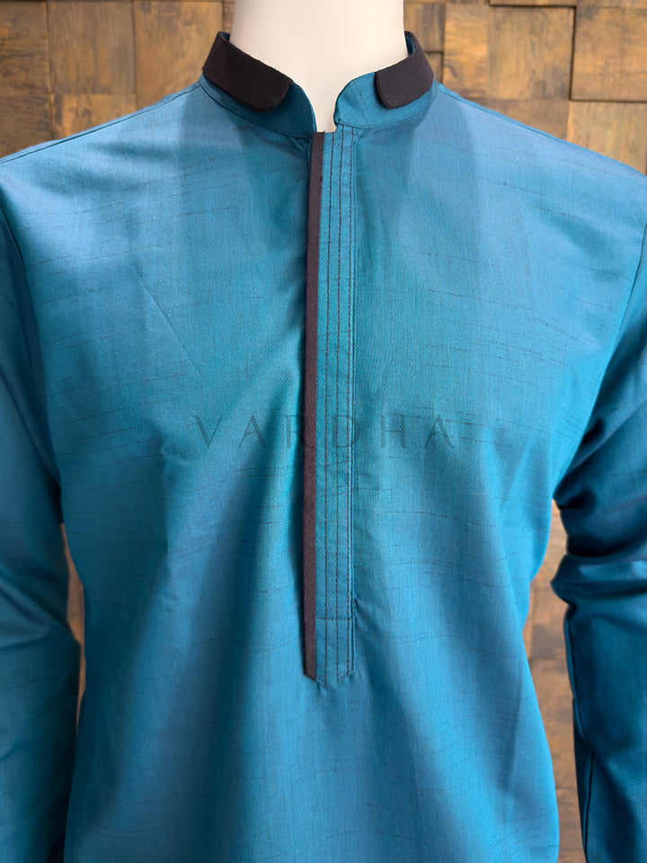 Close-up of a designer Teal Blue kurta showing the subtle woven slub texture, which provides tactile depth and a sophisticated festive sheen.