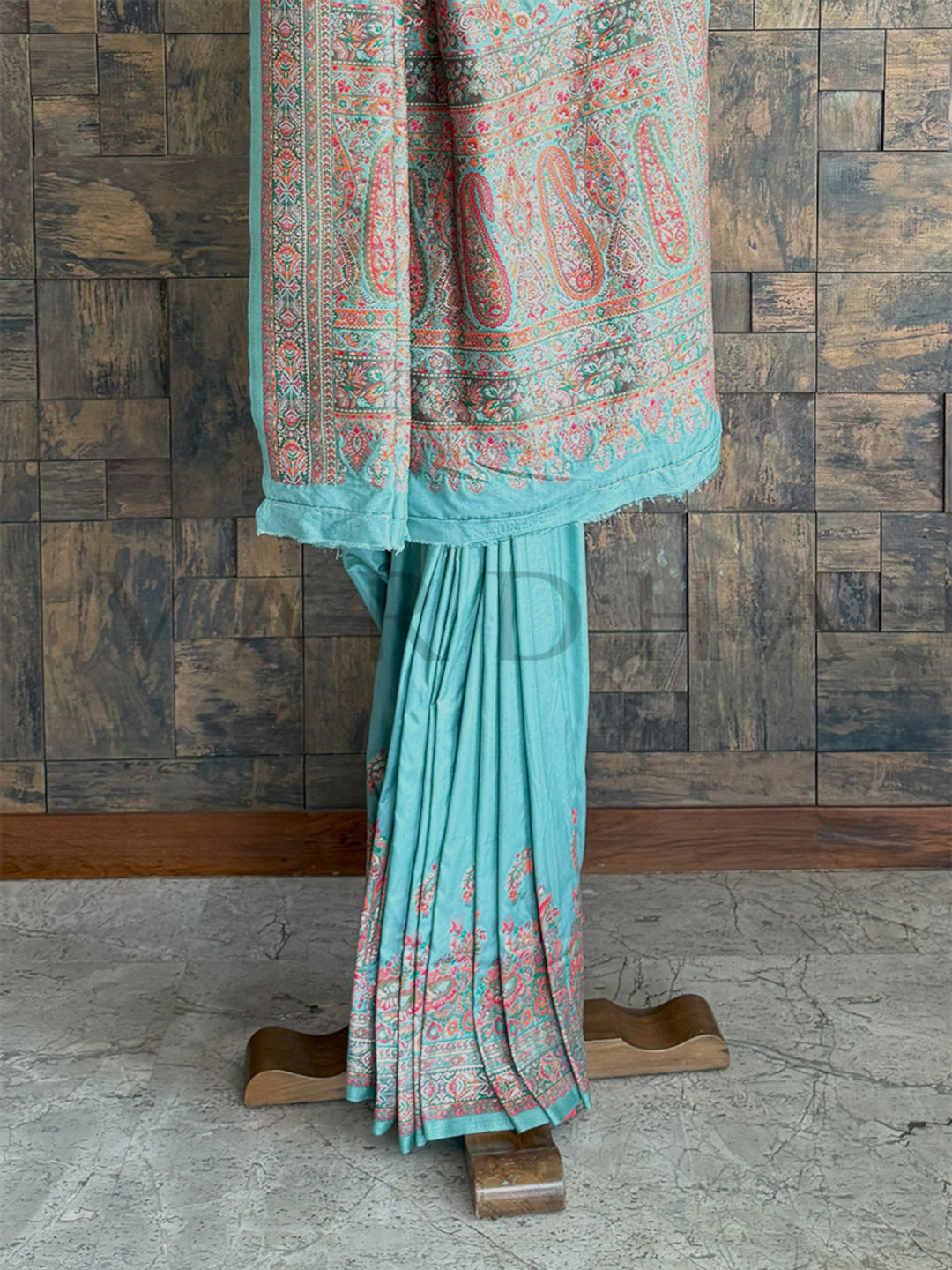 Stunning turquoise-blue Pashmina raw silk saree with fine embossed thread detailing, showcasing artisanal craftsmanship and refined beauty.