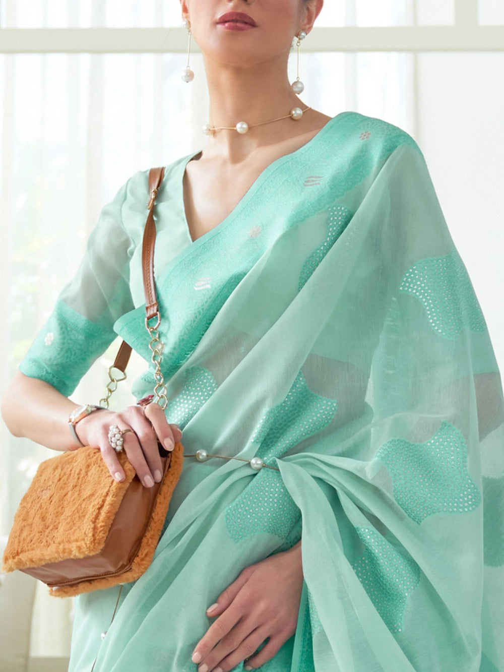 Elegant Turquoise Chikankari Georgette Saree adorned with Intricate Lucknowi Weaving, perfect for Bridal Wear and Cultural Celebrations.

