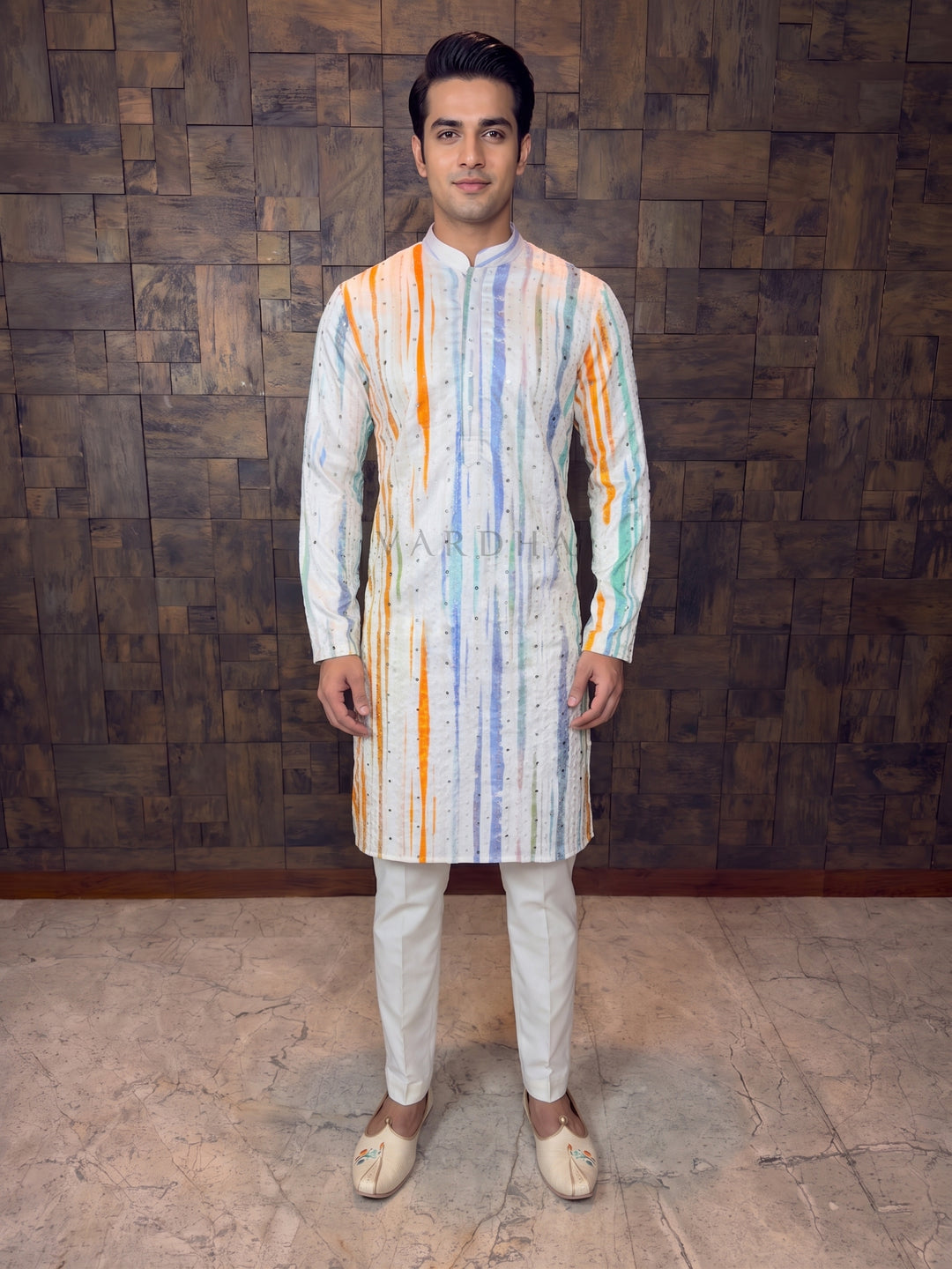 White Multi-Color Striped Kurta piece blends in modern prints with traditional embellishments. Crafted from premium Art Silk, kurta offers a festive sheen and a structured drape. It features striking, painterly vertical stripes in vibrant shades of Orange, Powder Blue, and Mint Green. The design is elevated by fine vertical embroidery lines dotted with shimmering mirror work, adding texture and a brilliant daytime sparkle.
