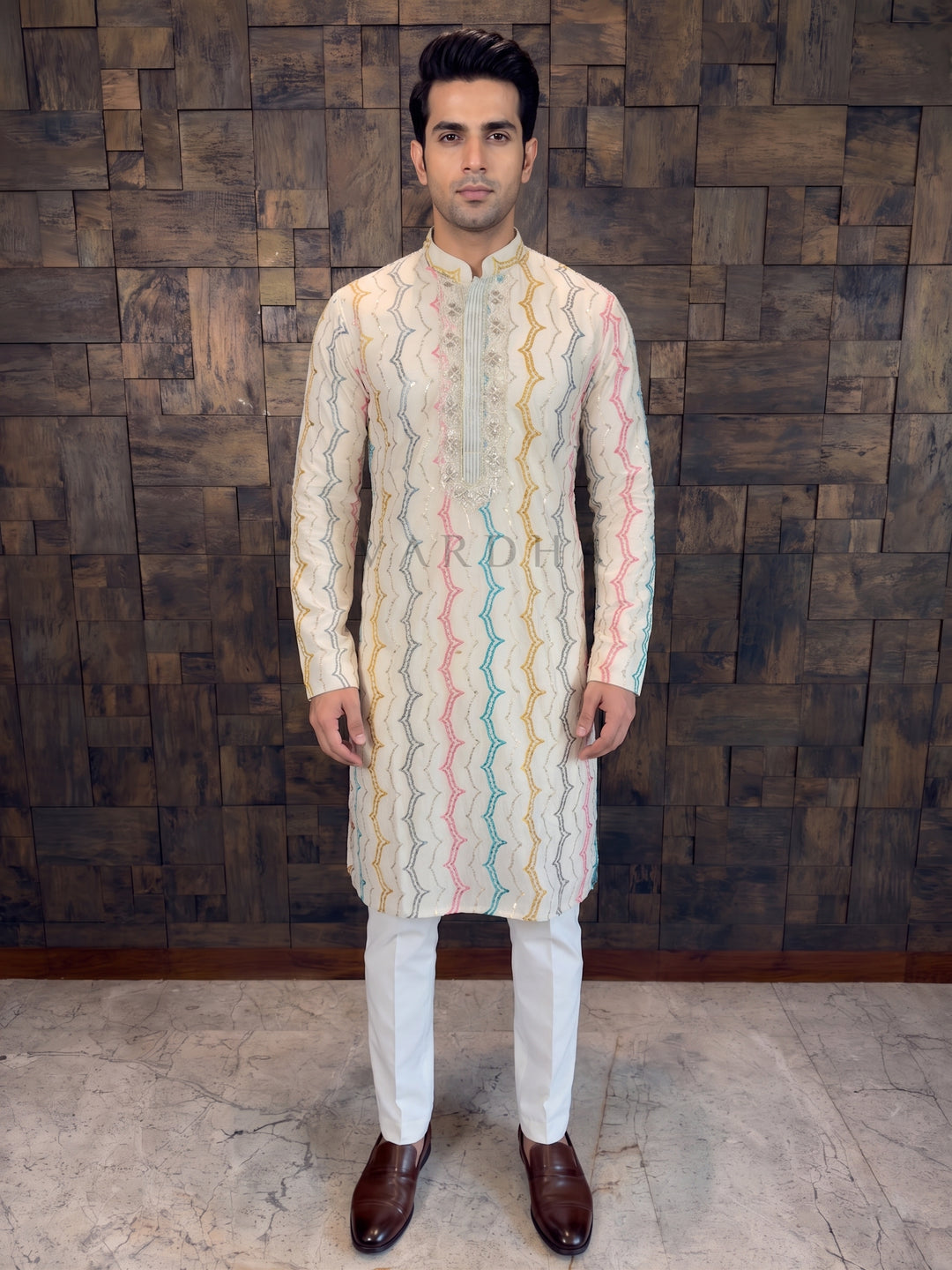 White Pure Cotton Designer Kurta. Crafted for ultimate comfort and breathability, this piece is a summer essential that doesn't compromise on festive flair. The kurta features a vibrant Multi-Color Zig-Zag (Chevron) Embroidery running vertically down the body. The wavy lines in Pink, Teal Blue, Mustard Yellow, and Grey are highlighted with delicate silver sequins, creating a playful yet sophisticated look.