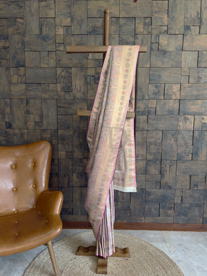 White and pink Kalamkari Art Silk Saree with zari floral motifs and brocade border. Elegant white art silk saree featuring rose accents, zari peacock patterns, and festive appeal.
