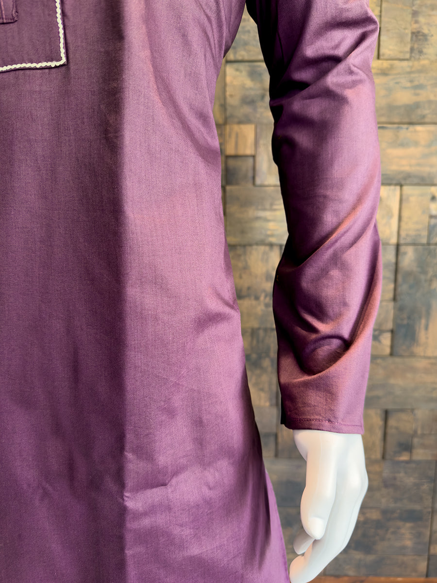 Close-up of a purple garment with a textured wooden background. Elegant jewel-toned Wine kurta for evening receptions and festive gatherings, highlighting a sophisticated silhouette and full sleeves.