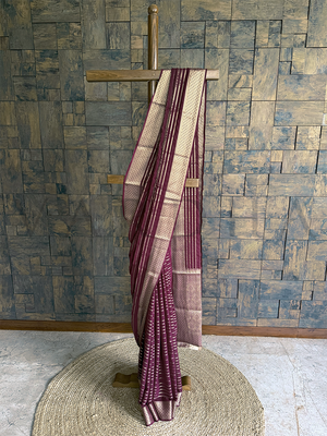 Wine georgette saree displayed on hanger with zari striped body, diamond jaal border, and contrast pallu for festive wear