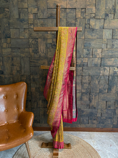 Yellow and Rani Kalamkari Art Silk Saree with rich zari border and floral motifs.. Traditional Yellow Kalamkari Saree in Art Silk featuring contrast Rani Pink blouse.
