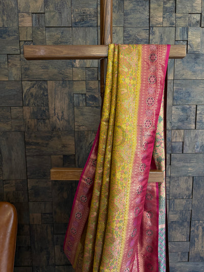 Festive Kalamkari Saree in Yellow with Zari Weaving and Rani borders for cultural events. Vibrant Yellow Zari Saree in Art Silk with peacock motifs and pink woven edge.
