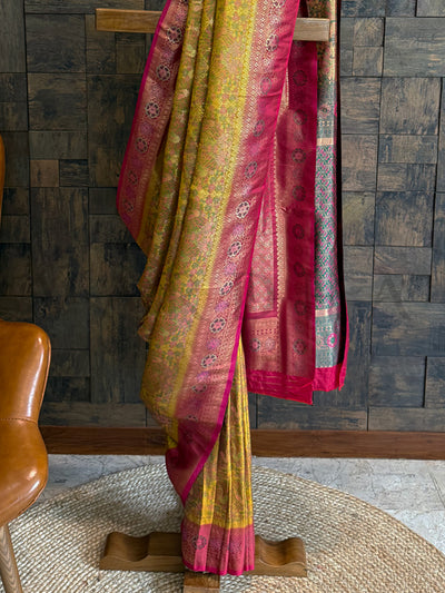Art Silk Kalamkari Saree in Yellow and Rani with floral patterns and zari work. Ethnic Yellow saree for festive occasions with rich brocade blouse and woven pallu.
