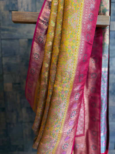 Yellow wedding-ready Kalamkari Art Silk Saree with zari highlights and bright contrast border. Contrast border Kalamkari silk saree in yellow with pink and gold detailing.
