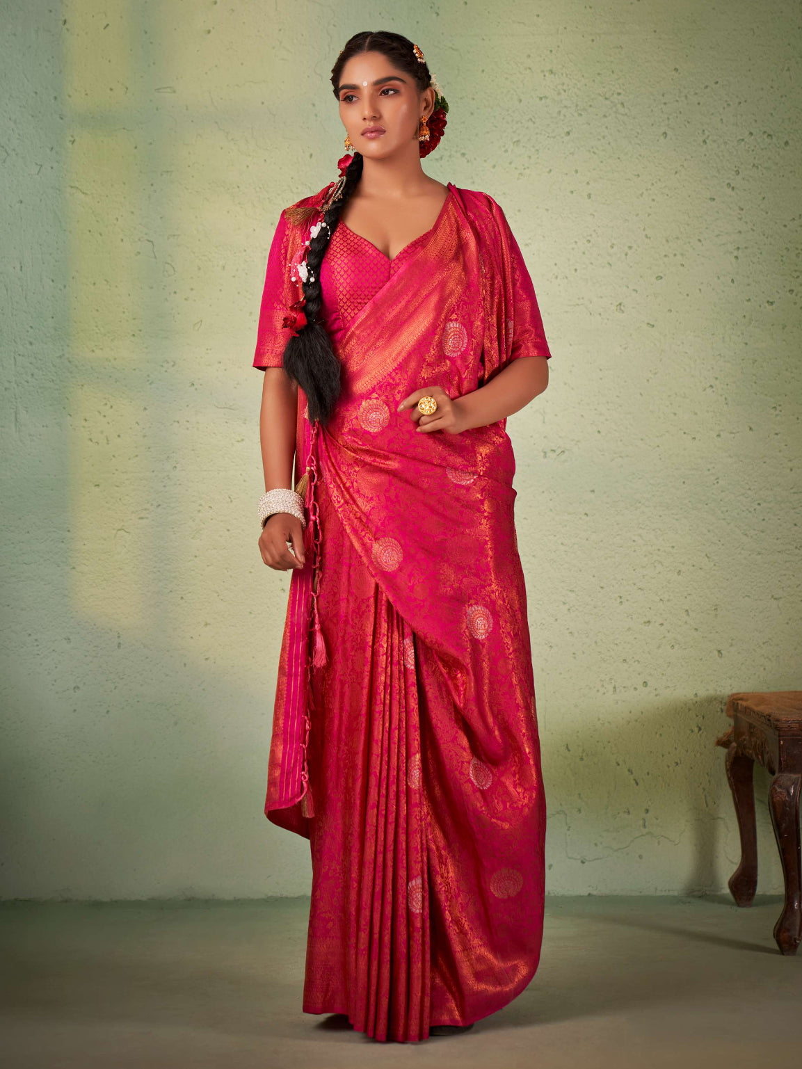 Barbie pink Kanjeevaram saree with shimmering copper zari draped elegantly.