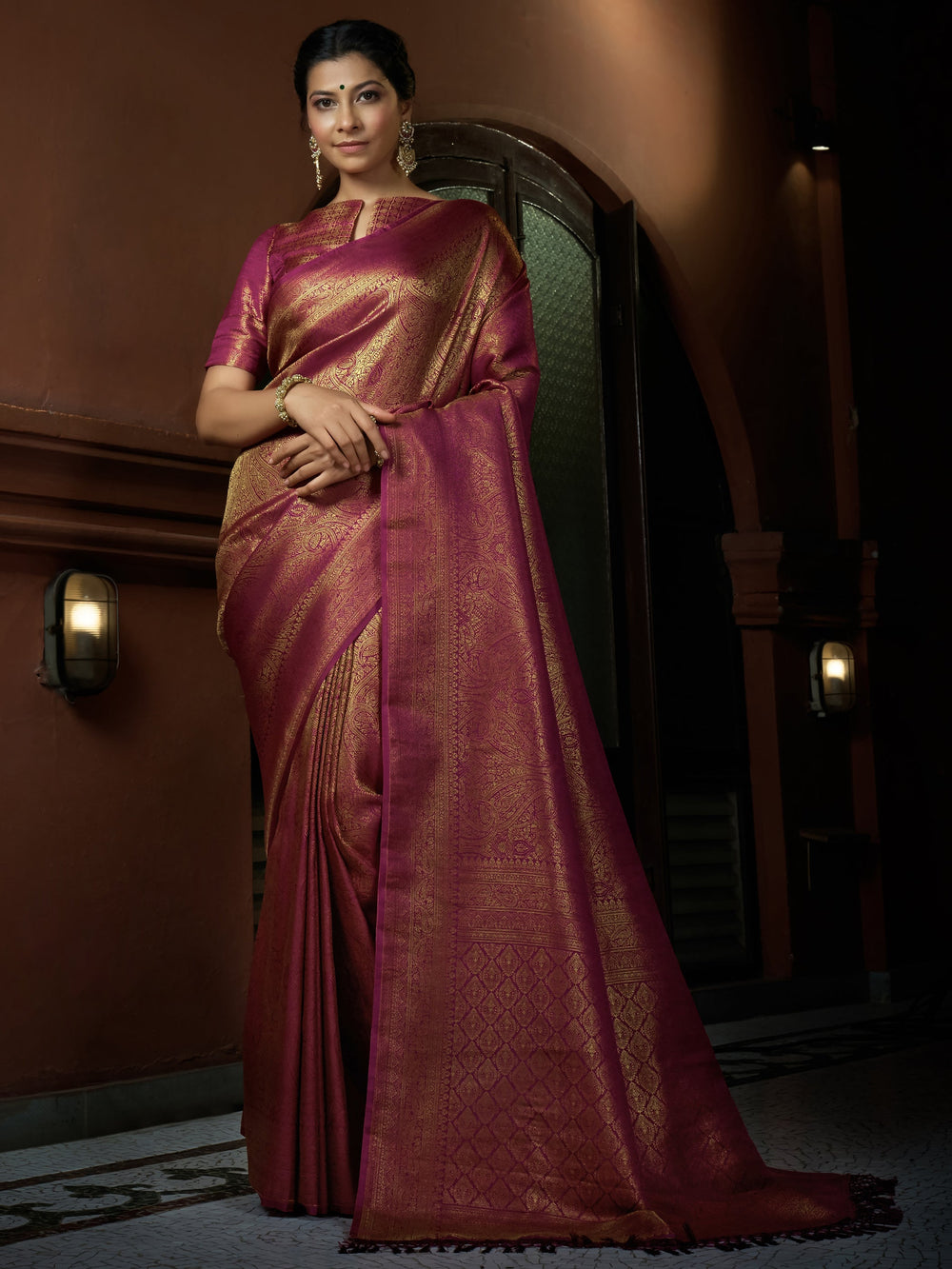 Flat lay image of saree with blouse piece, highlighting fabric texture and sheen.