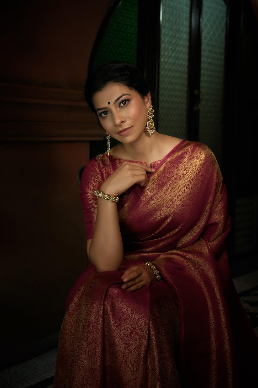 Rear view of the draped saree with a focus on the rich zari pallu and elegant fall.