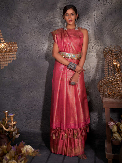 Model draped in blush red Kanjeevaram saree with gold, copper, and silver zari detailing.