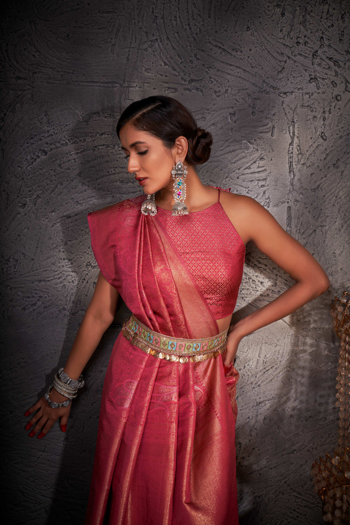 Close-up of pallu with intricate zari weaving and shimmering accents.