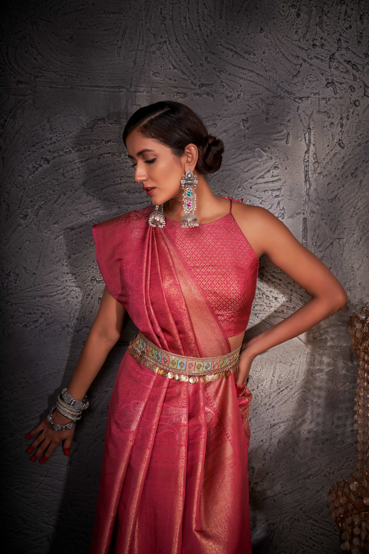 Close-up of pallu with intricate zari weaving and shimmering accents.