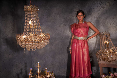 Blush red saree styled with antique jewelry for a traditional bridal look.