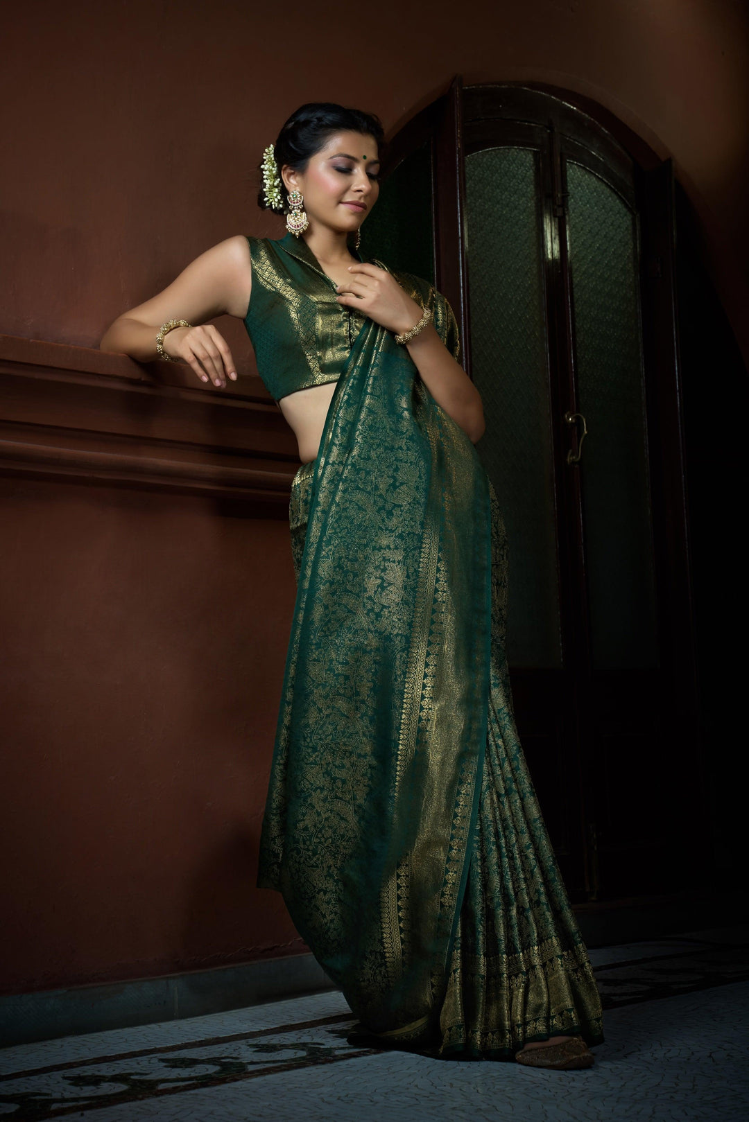 Side view of saree showing the pallu’s rich golden embroidery and flow.