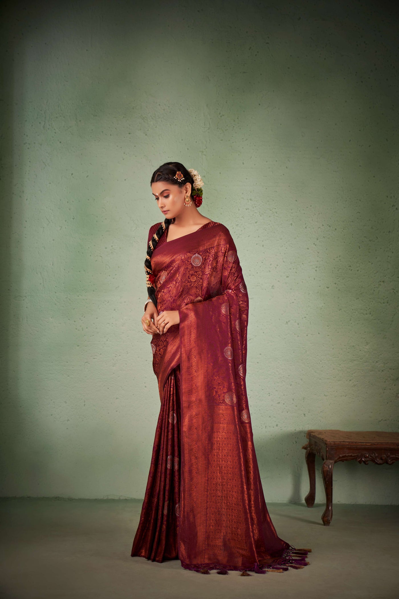 Back-drape view showcasing rich maroon pallu with copper zari.