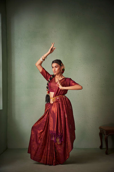 Maroon Kanjeevaram saree with copper zari and traditional border.