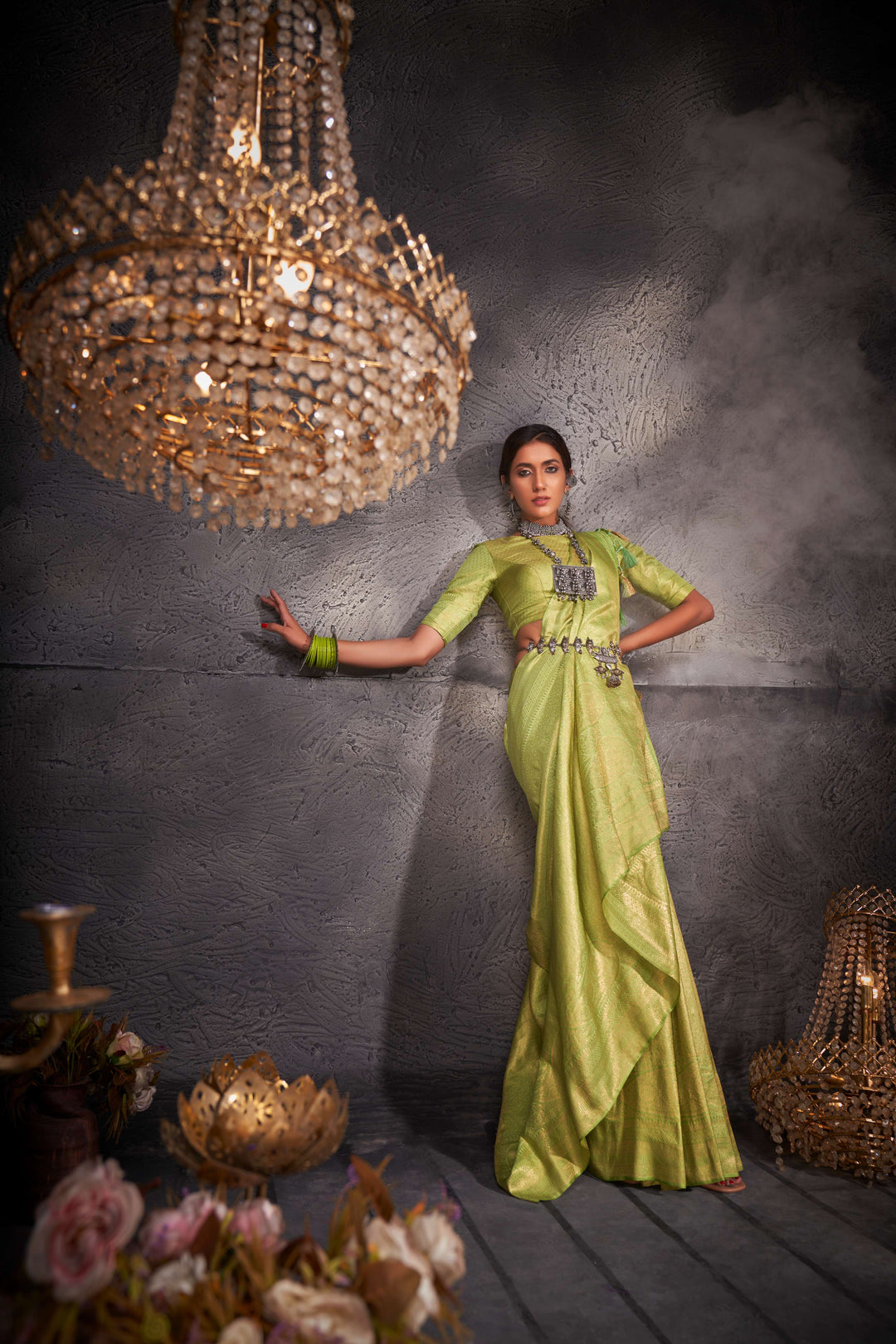 The pallu drape with shimmering gold patterns and smooth flow.