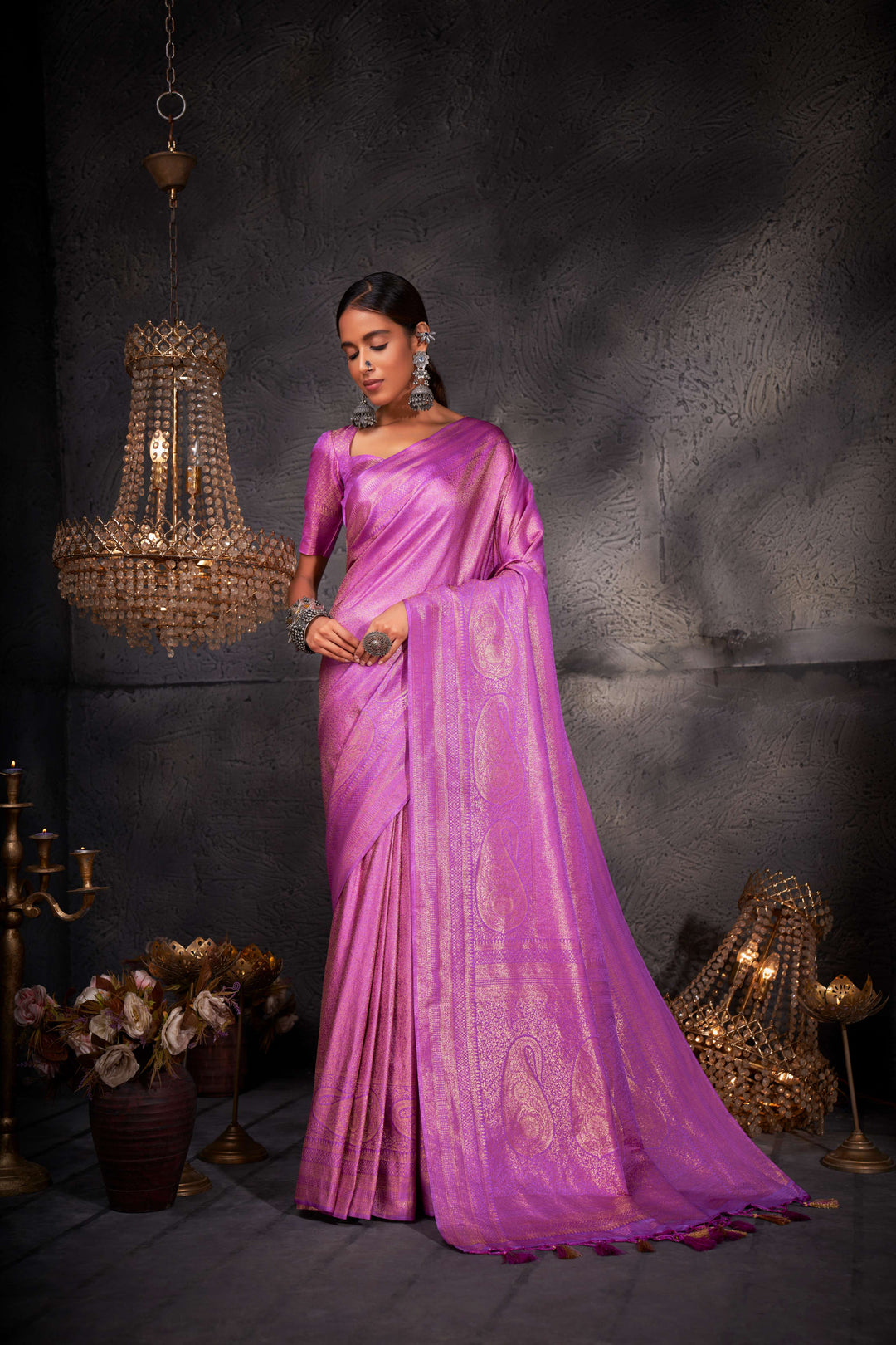 Full-length image focusing on the saree's elegant flow and shimmering zari detail.