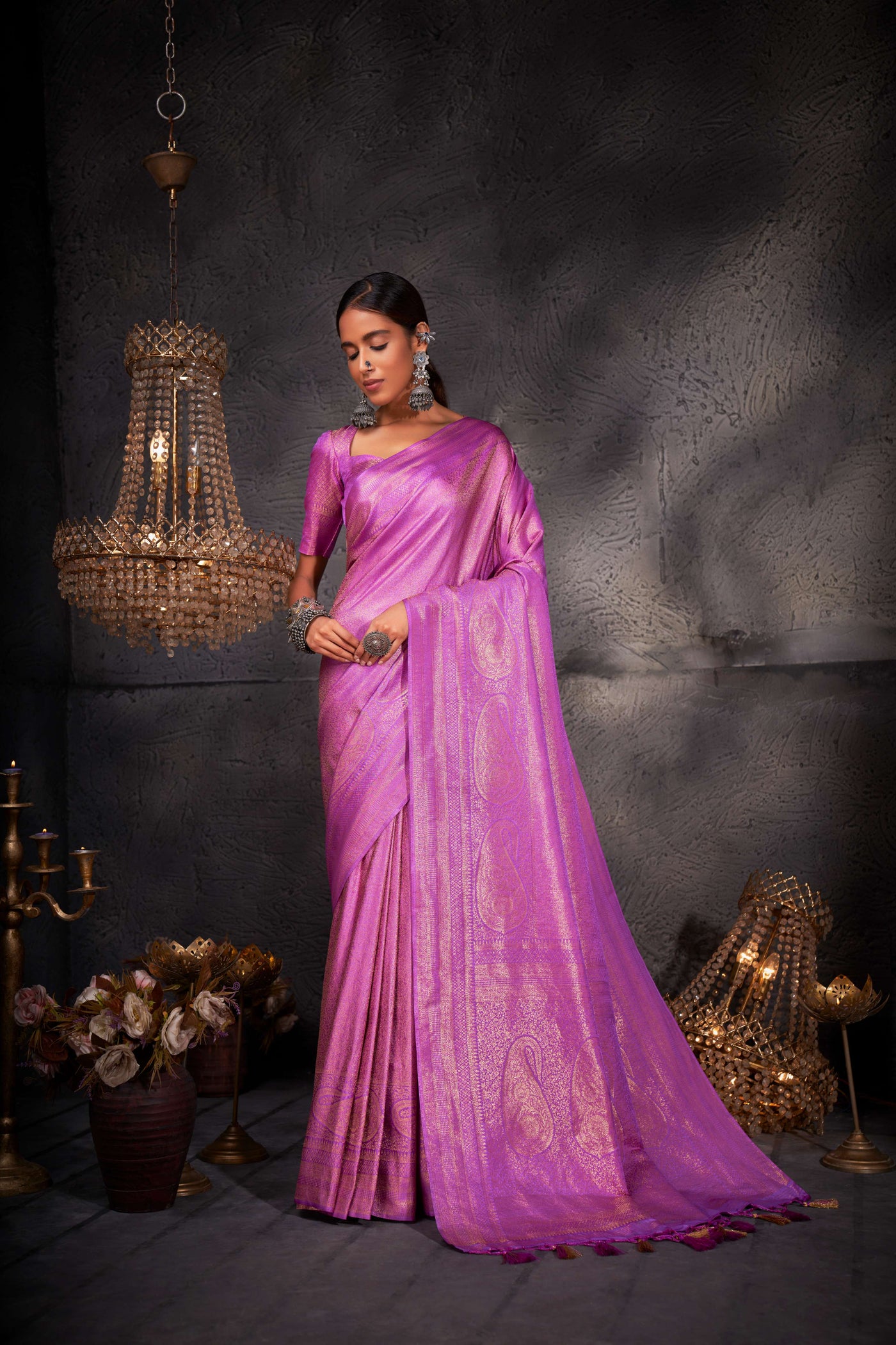 Full-length image focusing on the saree's elegant flow and shimmering zari detail.