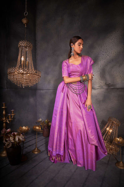 Close-up of intricate gold zari motifs woven into the soft lilac silk fabric.