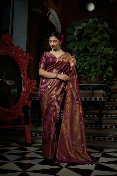 Floral butta motifs and dual-tone zari detailing on the body.