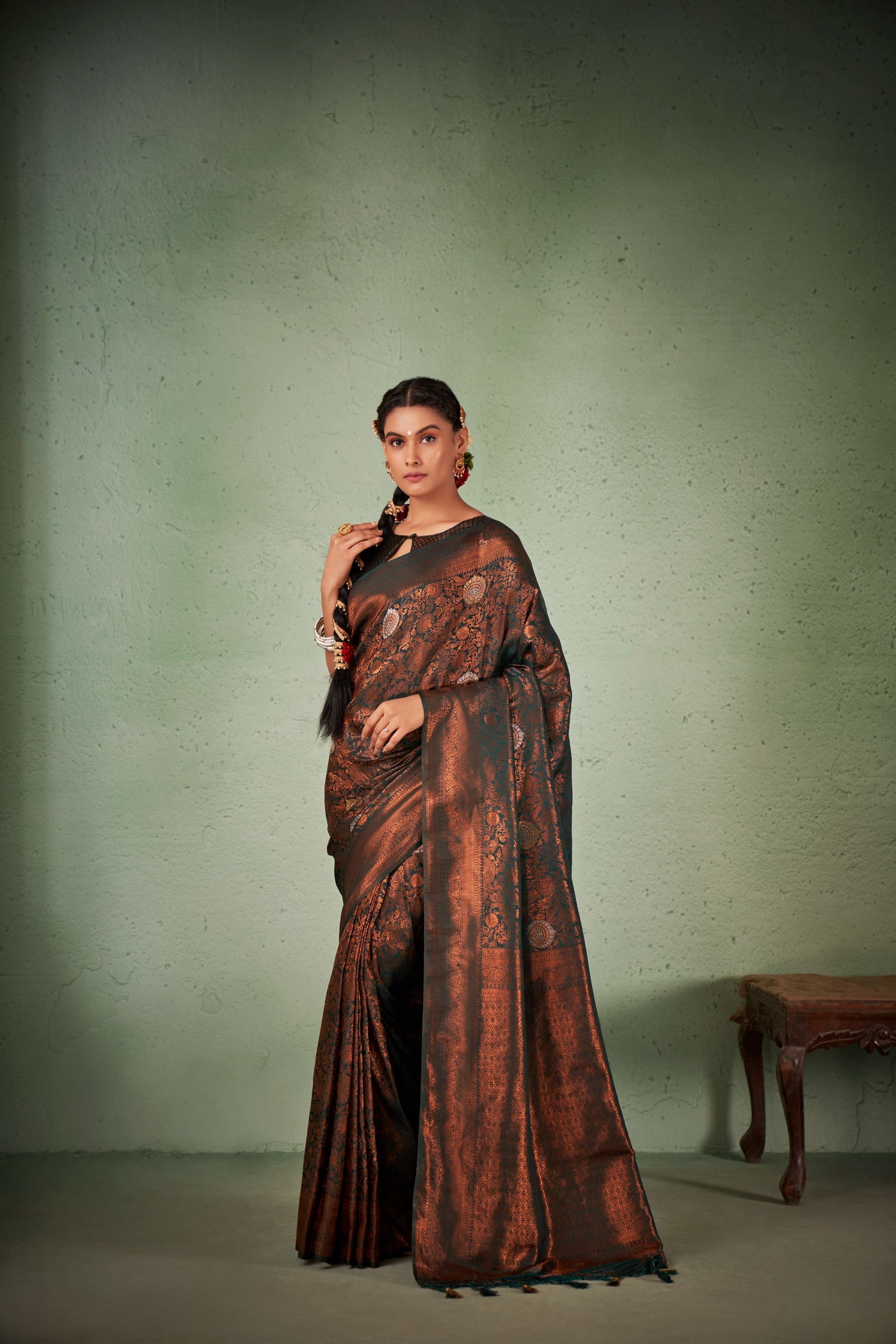 Full flat-lay of saree and blouse piece with jewelry accents.