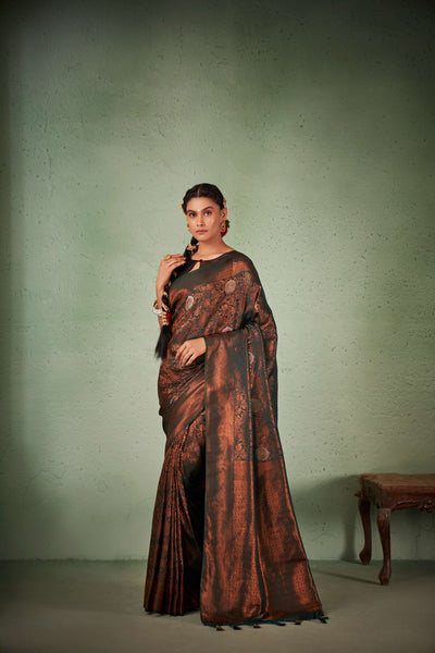 Full flat-lay of saree and blouse piece with jewelry accents.