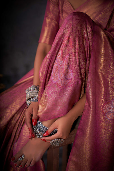 Detail shot of zari work gleaming under soft lighting.

