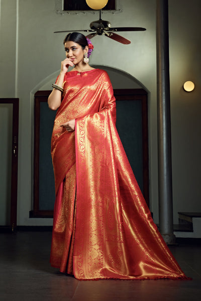 Model showcasing the saree’s pallu flow from the back with gold jewelry.
