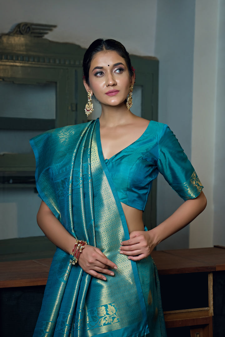 Close-up of the saree’s intricate gold zari work on the border and pallu.