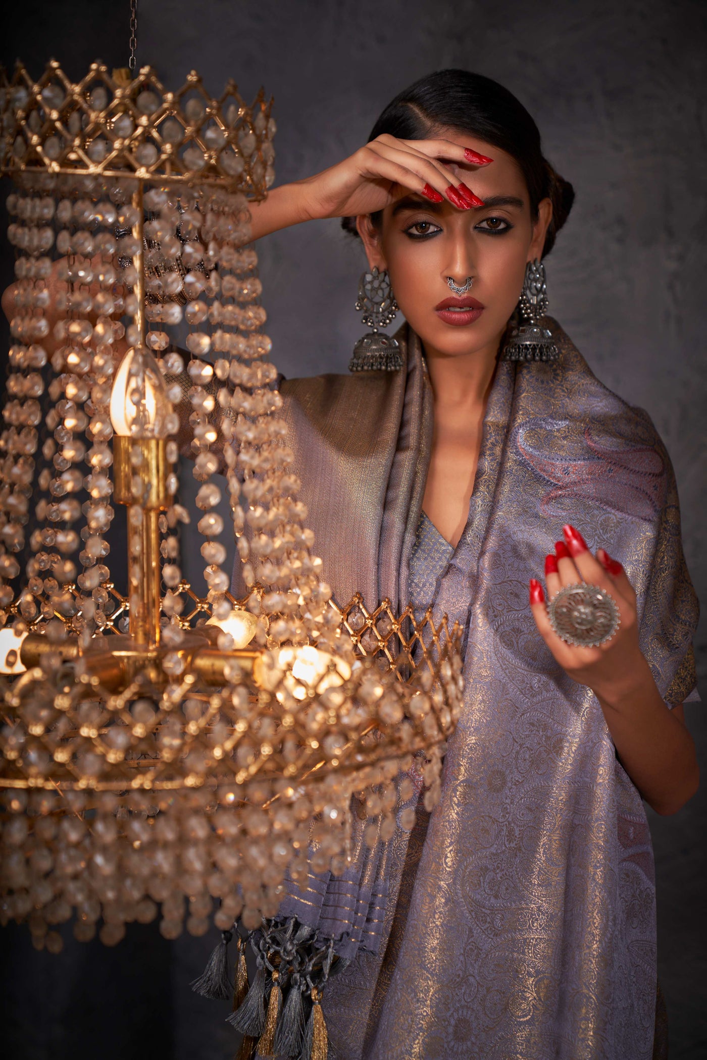 Close-up of multi-metallic zari work showcasing the fine craftsmanship and texture on grey silk.