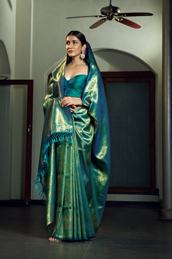 Flat-lay of the saree with blouse piece highlighting the zari work.