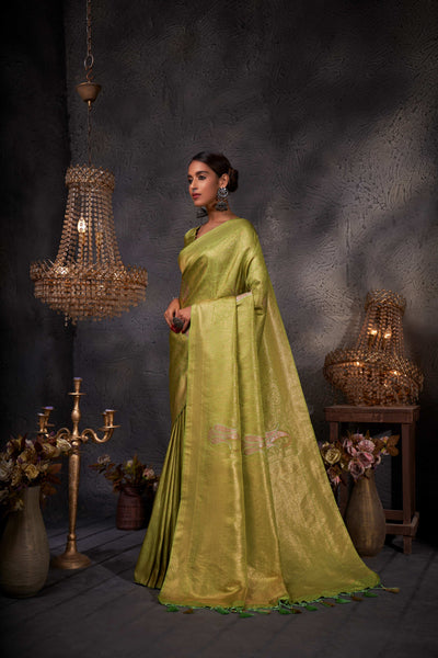Full-body shot showing the elegant drape and vibrant green tone of the saree.